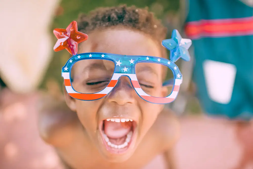 happy boy with american flag glasses on